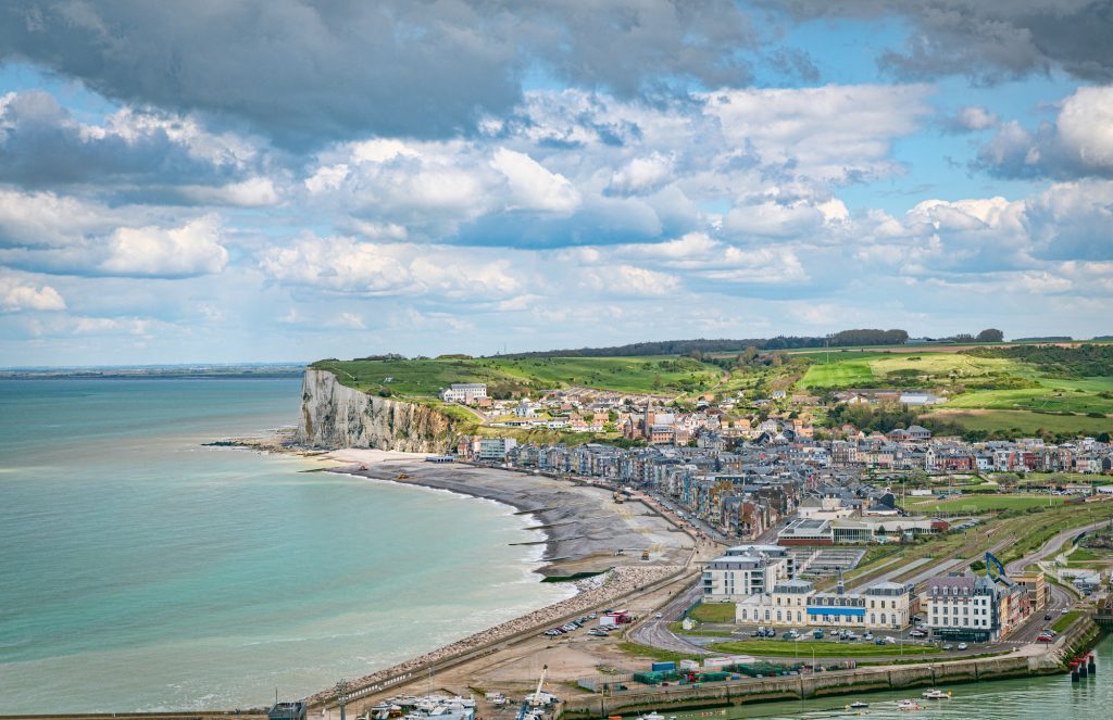 Aerial view of Le Treport with the rocks of etretat as background
